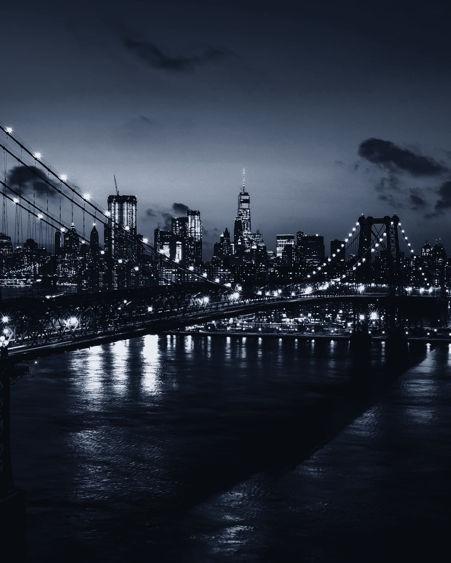 The Williamsburg Bridge and Manhattan skyline at dusk